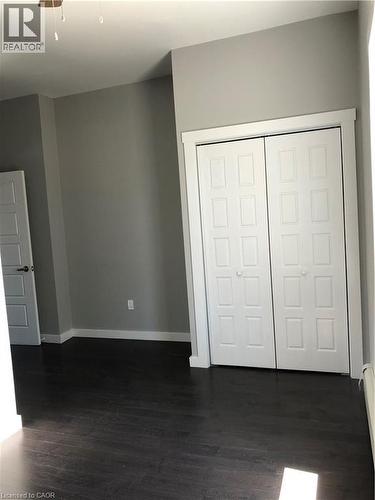 Unfurnished bedroom featuring dark wood-type flooring and a closet - 552 7Th Avenue, Hanover, ON - Indoor Photo Showing Other Room