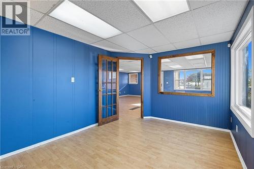 Empty room with light wood-style flooring and a drop ceiling - 1036 Upper Wentworth Street, Hamilton, ON 