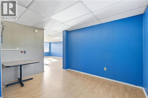 Empty room with wood finished floors, a paneled ceiling, and a decorative wall - 1036 Upper Wentworth Street, Hamilton, ON 