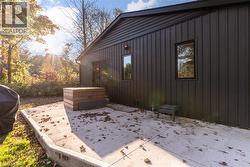 View of property exterior featuring a patio area and board and batten siding - 