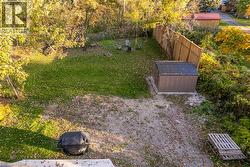 View of yard featuring a fire pit and a storage shed - 