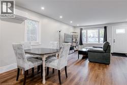Dining room with a wall mounted AC, healthy amount of natural light, wood finished floors, and recessed lighting - 