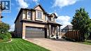 Craftsman inspired home with an attached garage, decorative driveway, covered porch, and stucco siding - 537 Millstream Drive, Waterloo, ON  - Outdoor 