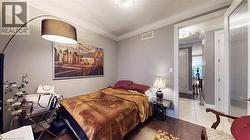Bedroom featuring wood finished floors and crown molding - 