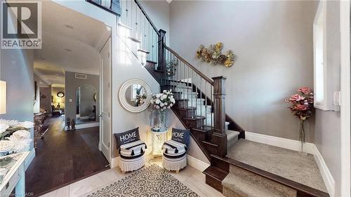 Stairs with arched walkways, tile patterned floors, and a towering ceiling - 537 Millstream Drive, Waterloo, ON - Indoor Photo Showing Other Room