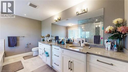 Bathroom with double vanity, a shower stall, and light tile patterned floors - 537 Millstream Drive, Waterloo, ON - Indoor Photo Showing Bathroom