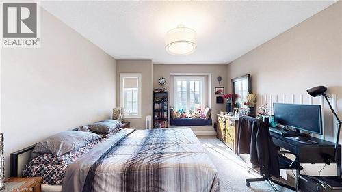 Bedroom with light colored carpet, a textured ceiling, and an office area - 537 Millstream Drive, Waterloo, ON - Indoor Photo Showing Bedroom