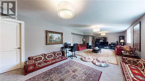 Carpeted living area featuring a textured ceiling and an office area - 537 Millstream Drive, Waterloo, ON - Indoor Photo Showing Other Room