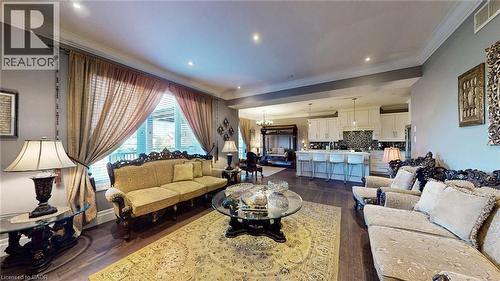 Living room with a chandelier, crown molding, dark wood-style floors, and recessed lighting - 537 Millstream Drive, Waterloo, ON - Indoor Photo Showing Living Room