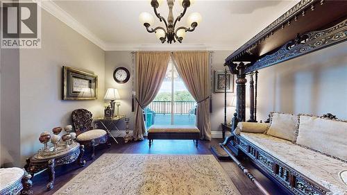 Sitting room with crown molding, dark wood-style flooring, and a chandelier - 537 Millstream Drive, Waterloo, ON - Indoor Photo Showing Other Room
