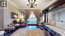 Sitting room with crown molding, dark wood-style flooring, and a chandelier - 