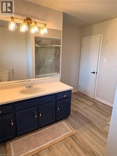 Bathroom featuring vanity, a marble finish shower, and light wood finished floors - 14 Windstar Place Unit# Upper, Hamilton, ON - Indoor Photo Showing Bathroom