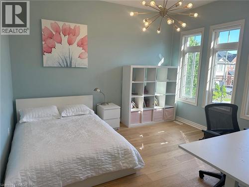 Bedroom featuring wood finished floors, a chandelier, and a desk - 2429 Whitehorn Drive, Burlington, ON - Indoor Photo Showing Bedroom