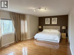 Bedroom with wood finished floors and a textured ceiling - 