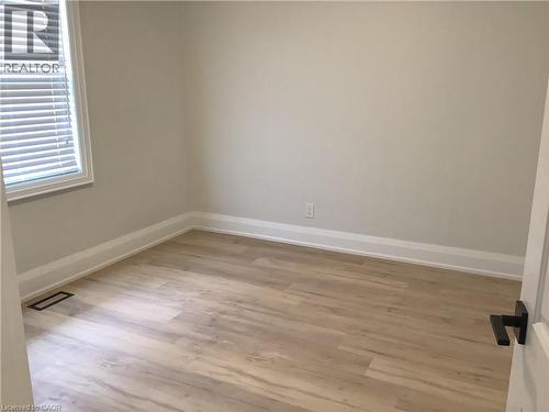 Empty room featuring light wood-style floors and baseboards - 229 West 18Th Street, Hamilton, ON - Indoor Photo Showing Other Room