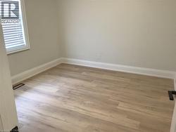 Empty room featuring light wood-type flooring - 