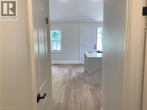 Hall featuring baseboards and light wood-type flooring - 229 West 18Th Street, Hamilton, ON - Indoor Photo Showing Other Room