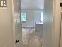 Hall featuring baseboards and light wood-type flooring - 