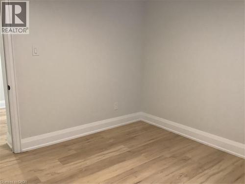 Empty room with light wood finished floors and baseboards - 229 West 18Th Street, Hamilton, ON - Indoor Photo Showing Other Room