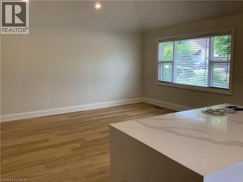 Unfurnished dining area with light wood-style flooring, recessed lighting, and vaulted ceiling - 229 West 18Th Street, Hamilton, ON - Indoor Photo Showing Other Room