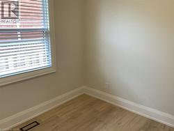 Unfurnished room with wood finished floors and baseboards - 