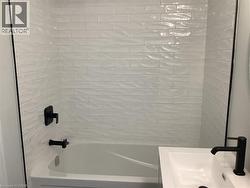 Bathroom with shower / tub combination and a sink - 