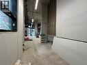 Corridor featuring unfinished concrete floors - 206 King Street W, Hamilton, ON 