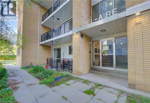 Entrance to property with board and batten siding and brick siding - 50 Gordon Avenue, Kitchener, ON - Outdoor With Balcony With Exterior