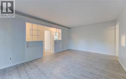 Spare room featuring light wood-style flooring and baseboards - 