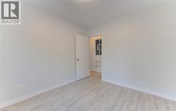 Empty room featuring light wood finished floors and baseboards - 