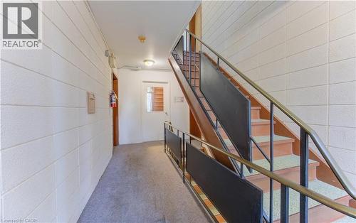 Stairs featuring carpet floors and concrete block wall - 50 Gordon Avenue, Kitchener, ON - Indoor Photo Showing Other Room