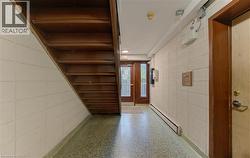 Hallway featuring baseboard heating and speckled floor - 