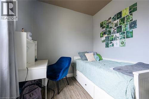 Bedroom featuring light wood-type flooring and baseboards - 129 Dundurn Street N, Hamilton, ON - Indoor Photo Showing Bedroom