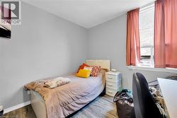 Bedroom with wood finished floors and baseboards - 