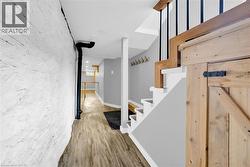 Stairway featuring wood finished floors and baseboards - 