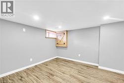Basement featuring recessed lighting, wood finished floors, and baseboards - 