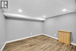 Finished basement featuring wood finished floors, baseboards, and recessed lighting - 