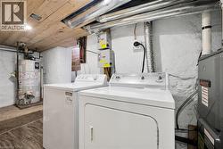 Clothes washing area with gas water heater and washer and clothes dryer - 