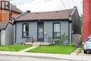View of front of house with brick siding, a gate, a shingled roof, and a front yard - 129 Dundurn Street N, Hamilton, ON  - Outdoor 