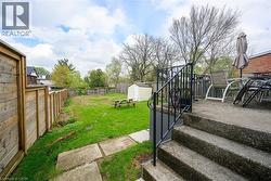 View of yard featuring a storage shed, an outdoor structure, and a patio area - 