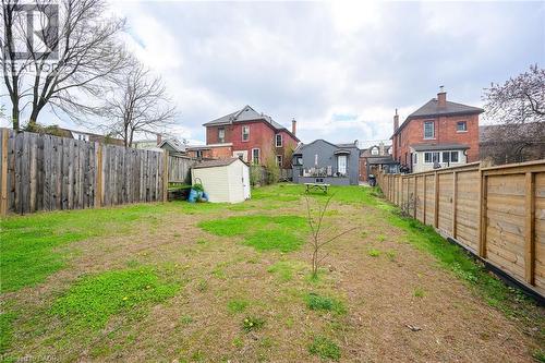View of yard featuring a storage shed, an outbuilding, and a residential view - 129 Dundurn Street N, Hamilton, ON - Outdoor