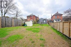 View of yard featuring a storage shed, an outbuilding, and a residential view - 