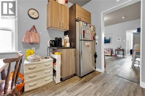 Kitchen with freestanding refrigerator and light wood-style floors - 129 Dundurn Street N, Hamilton, ON - Indoor