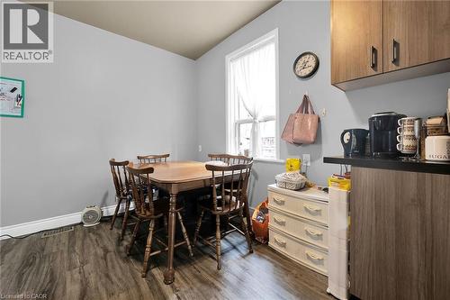 Dining space with dark wood-style flooring, healthy amount of natural light, and baseboards - 129 Dundurn Street N, Hamilton, ON - Indoor Photo Showing Dining Room