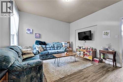 Living area featuring wood finished floors and baseboards - 129 Dundurn Street N, Hamilton, ON - Indoor Photo Showing Living Room