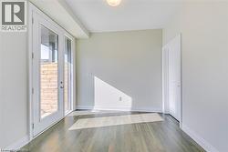 Spare room with wood finished floors and french doors - 