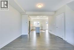 Unfurnished living room with dark wood-type flooring - 