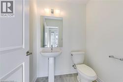 Bathroom featuring toilet and baseboards - 