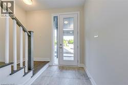 Entrance foyer with stairway and baseboards - 