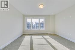 Empty room featuring light carpet - 